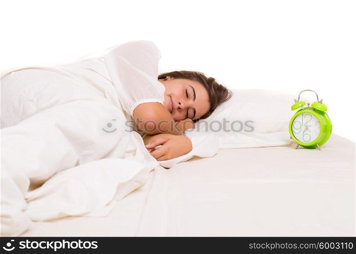 Woman waking up with the sound of the alarm clock