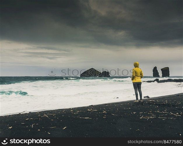 Woman walking  alone in a wild beach