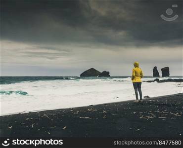 Woman walking  alone in a wild beach