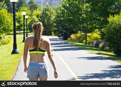 Woman walking along a jogging trail