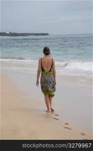 Woman walking along the beach in Bali