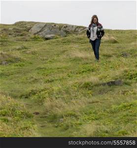 Woman walking at North Bird Island, Little Catalina, Bonavista Peninsula, Newfoundland And Labrador, Canada