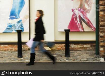Woman walking by a store window