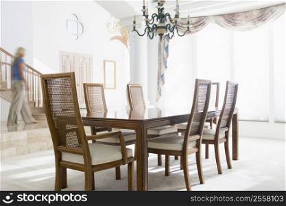 Woman walking by dining room