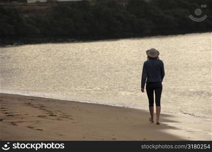 woman walking down beach