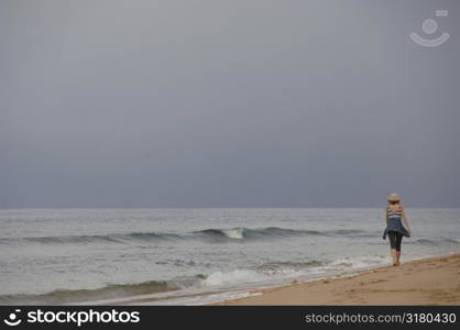 Woman walking down beach