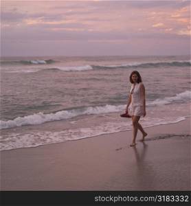 Woman walking down beach