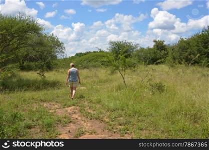 woman walking en enjoy nature with bleu sky and white clouds in africa