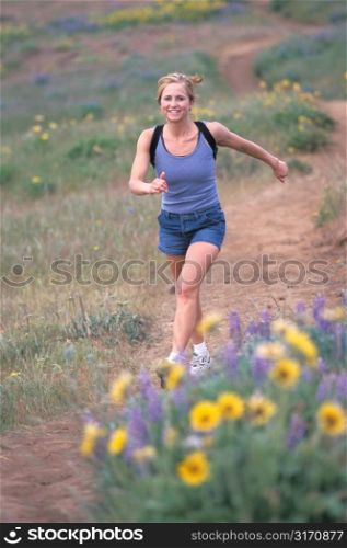 Woman Walking Fast in Field With Yellow Flowers
