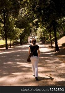 Woman walking in a park in Rome Italy