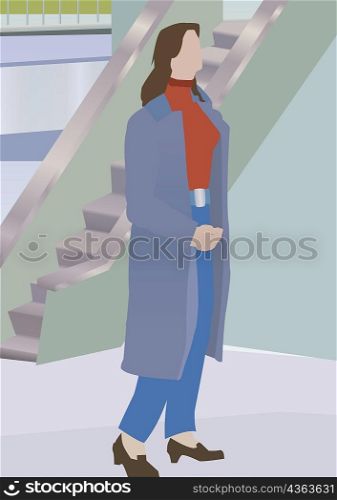 Woman walking in front of a stairway
