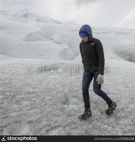 Woman walking in ice on Perito Moreno Glacier, Los Glaciares National Park, Santa Cruz Province, Patagonia, Argentina