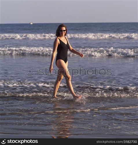 Woman walking in ocean