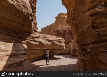 woman walking in the red canyon in israel. woman in the red canyon