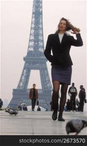 Woman walking near Eiffel Tower, Paris, France