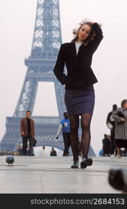 Woman walking near Eiffel Tower, Paris, France