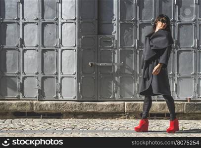 Woman walking on a street. Grey background. Bulgaria