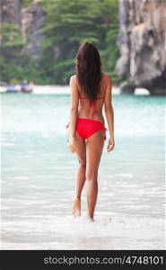 Woman walking on beach. Beautiful woman in bikini on beach at Maya bay, Thailand