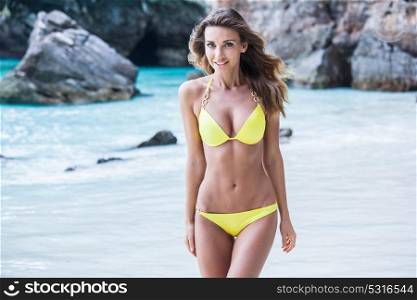 Woman walking on beach. Beautiful woman in bikini on beach at Maya bay, Thailand