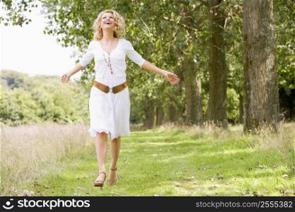 Woman walking on path smiling