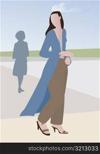 Woman walking on the sidewalk
