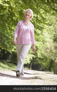 Woman walking outdoors smiling