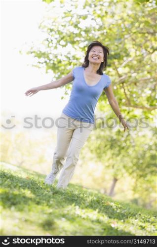 Woman walking outdoors smiling