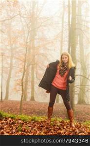 Woman walking relaxing in foggy day in romantic autumn forest park outdoor