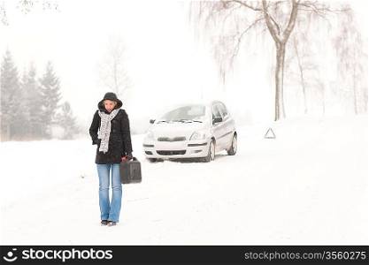 Woman walking with gas can snow car road winter trouble