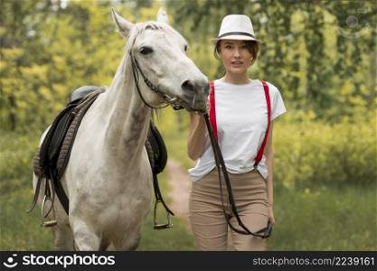woman walking with horse countryside