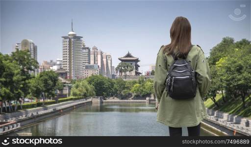 woman walks around the city of Xi&rsquo;an. China