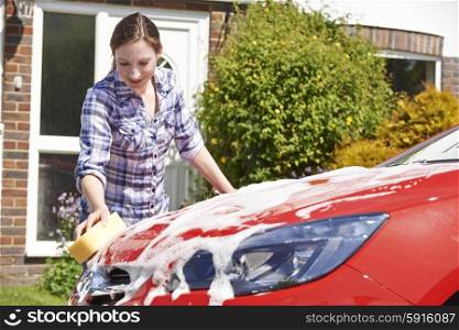 Woman Washing Car Outside House