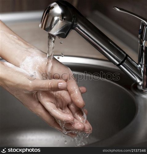 woman washing hands sink