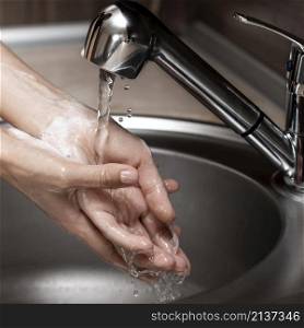 woman washing hands sink
