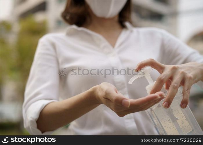 Woman washing hands with alcohol gel or sanitizer gel. corona virus or Covid-19 protection.