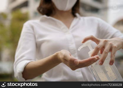 Woman washing hands with alcohol gel or sanitizer gel. corona virus or Covid-19 protection.