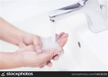 Woman washing hands With soap to protect against Corona virus or Covid 19