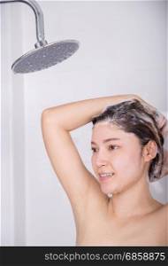 woman washing her head and hair by shampoo