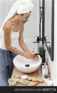 woman washing off natural ingredients from her hands