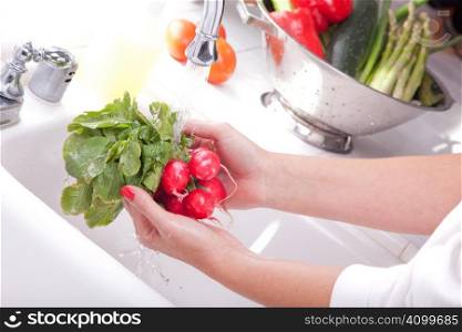 Woman Washing Radish in the Kitchen Sink.