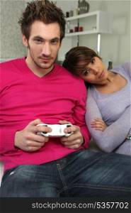 Woman watching boyfriend play video-games