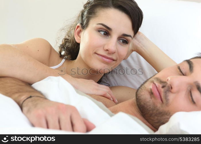 Woman watching her partner sleep