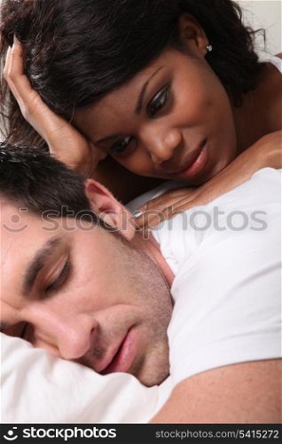 Woman watching man asleep