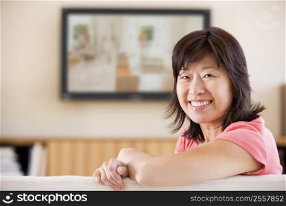 Woman watching television smiling