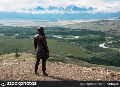 Woman watching to glacier in Altai mountains. Resting in mountains or global warming concept. Woman in the mountain