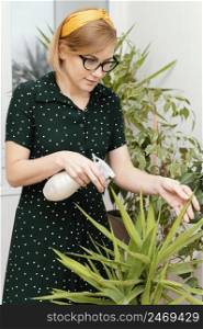 woman watering houseplant