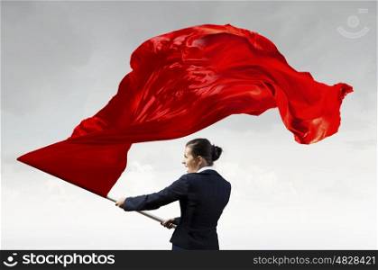 Woman waving red flag. Determined businesswoman waving flag as symbol of women power