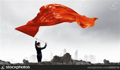 Woman waving red flag. Young determined businesswoman with red flag in hands