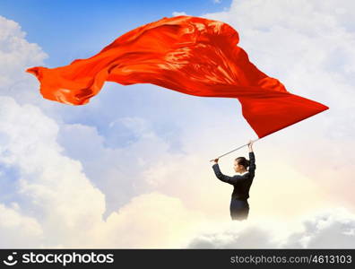 Woman waving red flag. Young determined businesswoman with red flag in hands