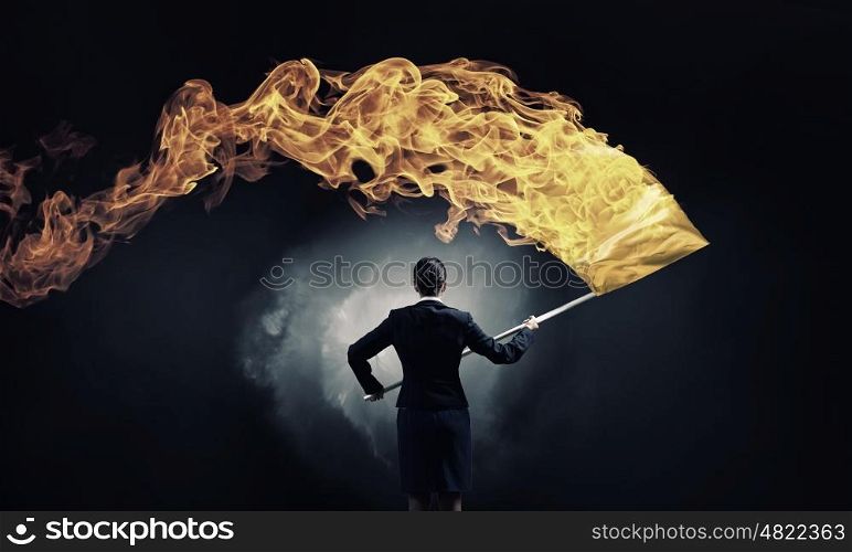 Woman waving yellow flag. Determined businesswoman waving flag as symbol of power